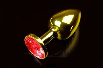 Маленькая золотистая анальная пробка с круглым кончиком и красным кристаллом - 7 см. от Пикантные штучки
